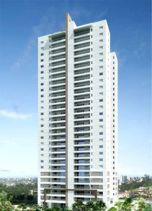 Perspectiva do edifício residencial Dommo Prime, torre alta e branca contra o céu azul.