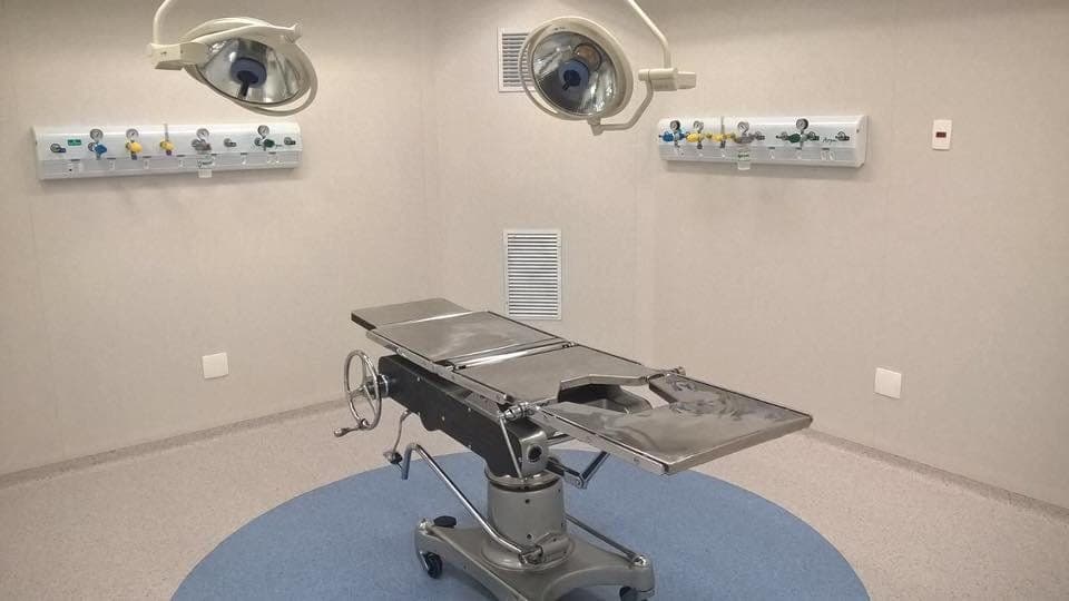 Sala de cirurgia reformada, com mesa cirúrgica e foco de luz no teto.